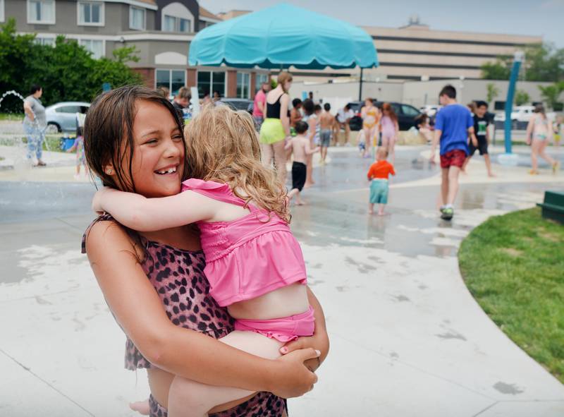 Families and children enjoy the new splash pad facilities. The Greater Newton Area Chamber of Commerce, Newton Main Street and the City of Newton held a ribbon cutting ceremony for the splash pad on June 6.