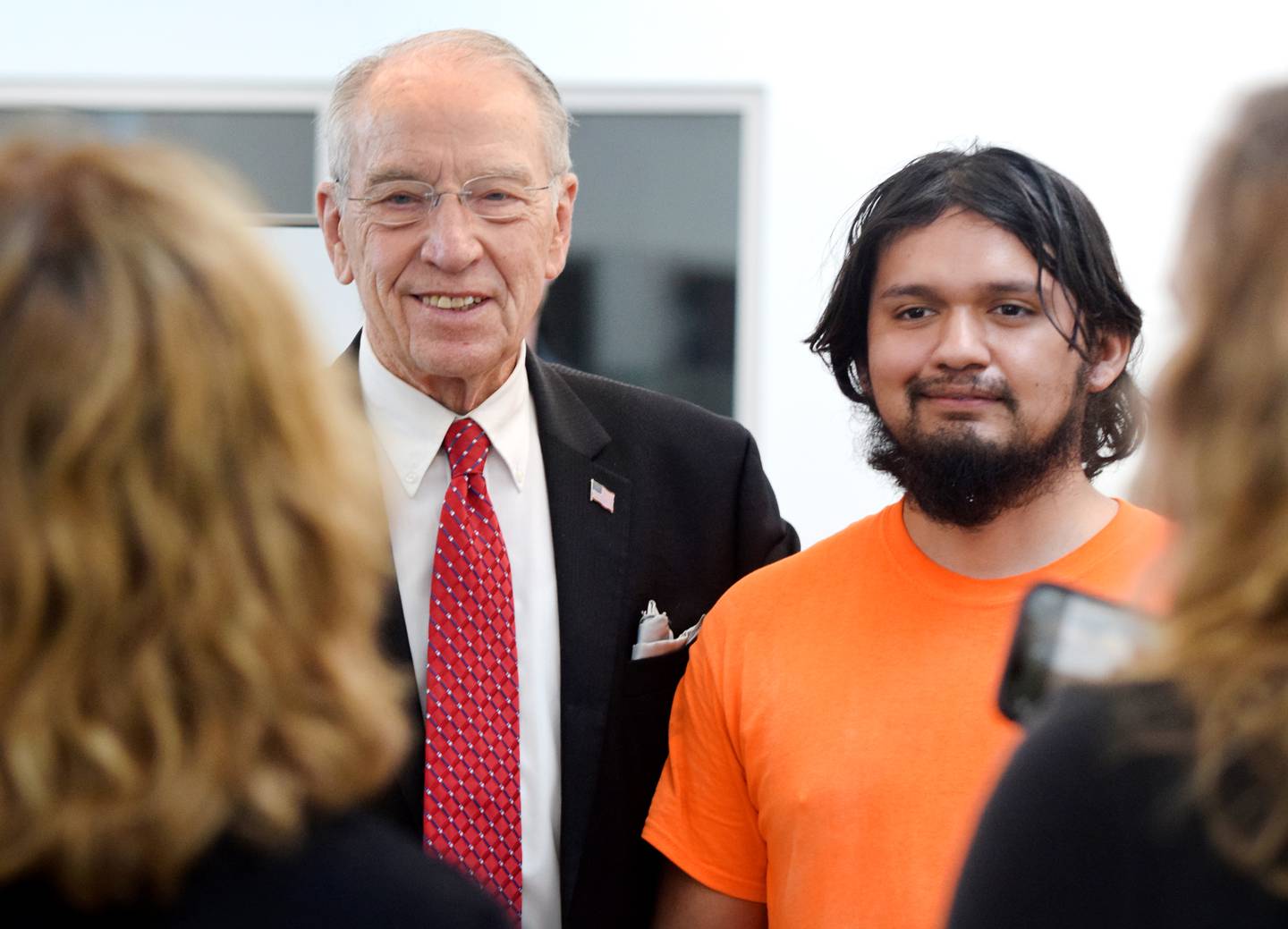U.S. Sen. Chuck Grassley, R- Iowa, poses for pictures with workers of VanMaanen Electric, Inc. during his 99-county tour on May 13 in Newton.