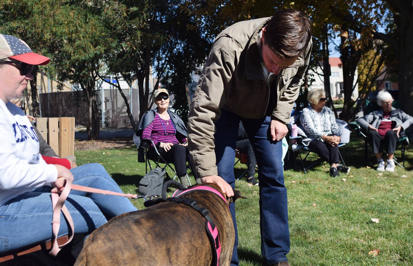 Iowa State Auditor Rob Sand greets a four-legged constituent during a visit Oct. 10 in Newton.