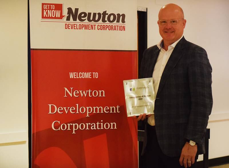 Jake Christensen of Christensen Development shows off his award he received from Newton Development Corporation during its Salute to Business and Industry luncheon on Oct. 10 in DMACC Newton Campus.