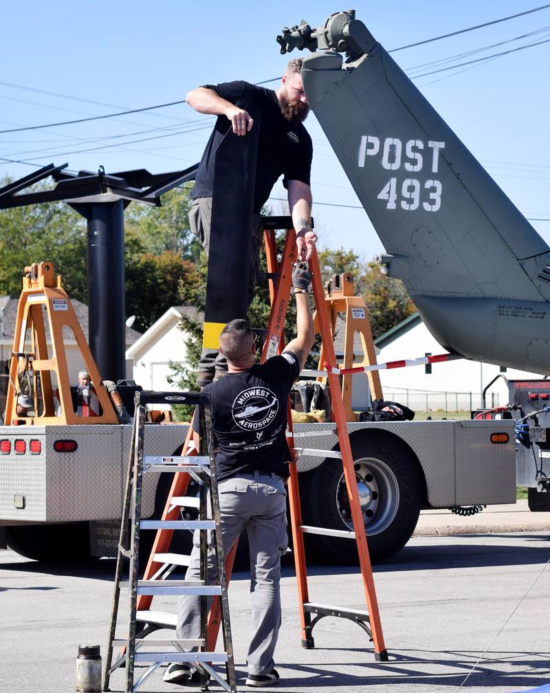 Crews from Midwest Aerospace prepare a  Huey helicopter monument on Sept. 30 in Baxter.