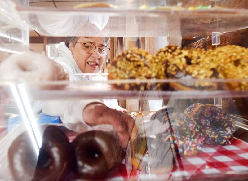 Lorie Ganoe, manager of the Newton Maid-Rite, loads freshly made donuts into a box for customers early in the morning on April 1 inside the downtown Newton restaurant. Newton Maid-Rite brought back the customer favorite after a three-year hiatus.