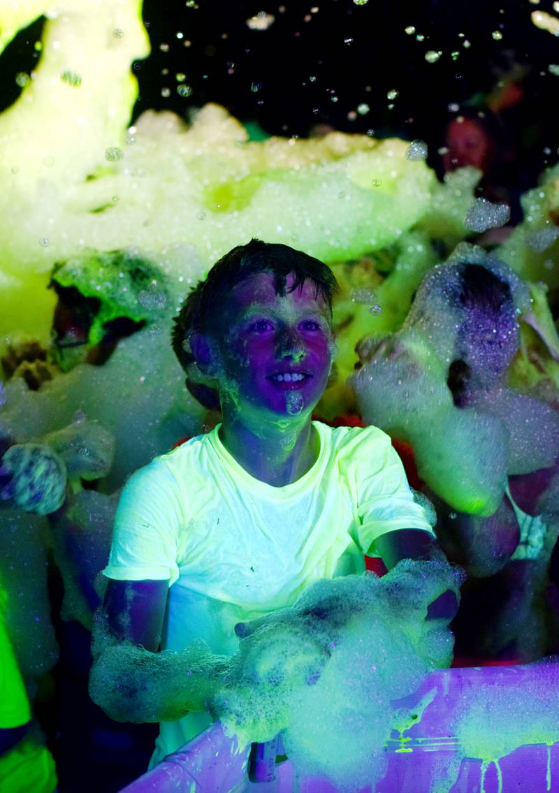 Kids enjoy the return of the Glow Foam Party – which featured two cannons this year – during Newton Fest on June 7 at Maytag Park.
