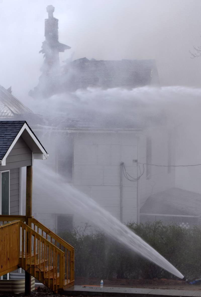 Firefighters from multiple agencies in Jasper and Polk Counties respond to a house fire on Thursday, April 20, near the 300 block of South Walnut Street in Colfax.