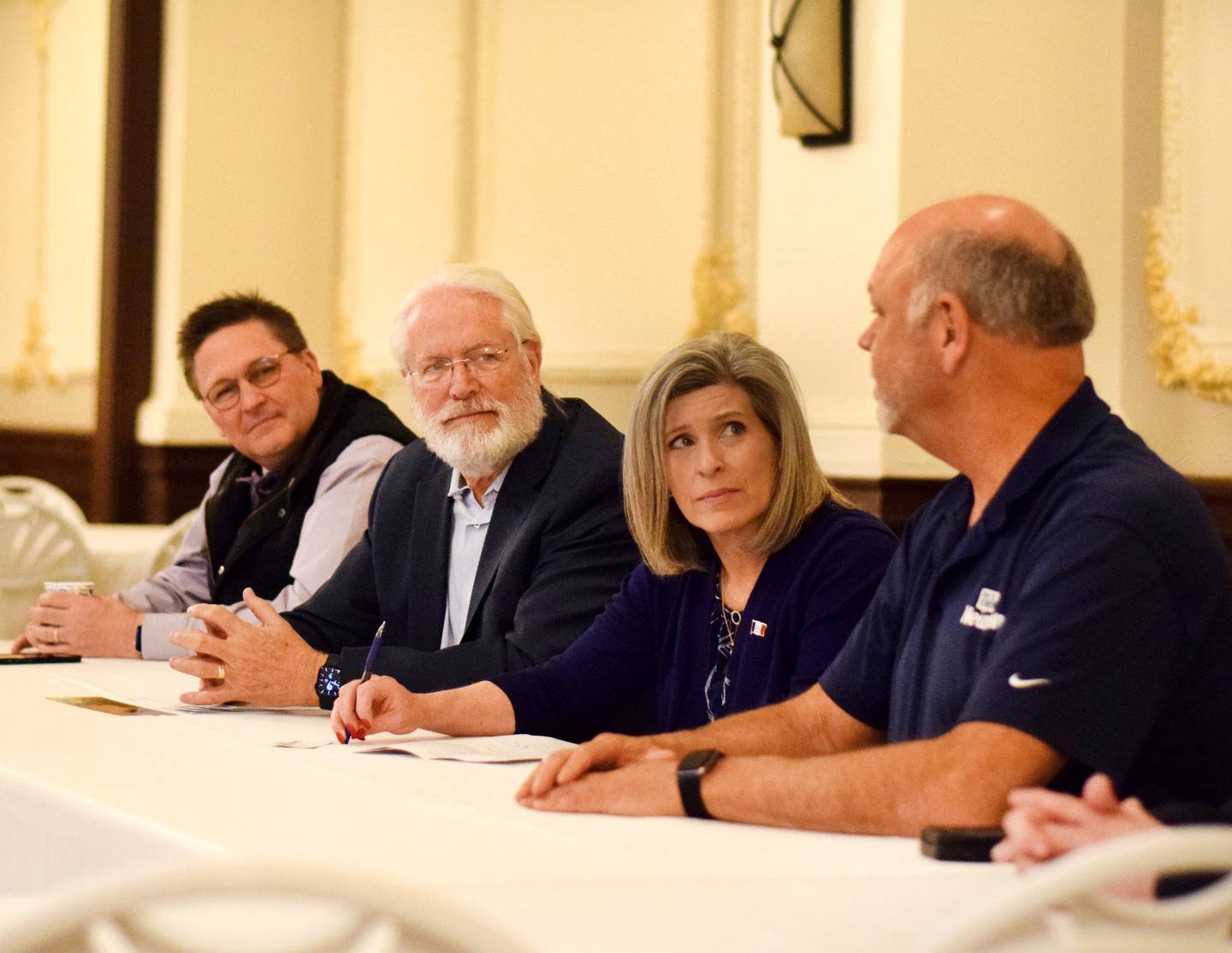 From left: Iowa House Rep. Jon Dunwell, developer Jack Hatch, U.S. Sen. Joni Ernst and Newton Mayor Mike Hansen discuss the restoration of Hotel Maytag on April 20 inside the Hotel Maytag ballroom in Newton.