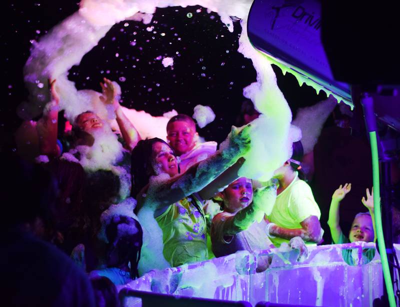 Kids enjoy the return of the Glow Foam Party – which featured two cannons this year – during Newton Fest on June 7 at Maytag Park.