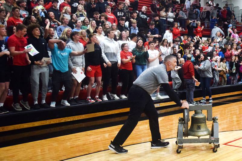 Jim Beerends, assistant principal of Newton High School, wheels out a victory bell after The Big Game on April 19 at Newton High School.