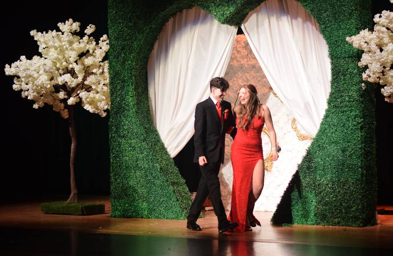 High schoolers pose for photographs before and after entering the auditorium for prom night on Aug. 15 at the Newton High School. Cardinals met for photos at a heart-shaped display on the stage before enjoying the festivities of prom night.