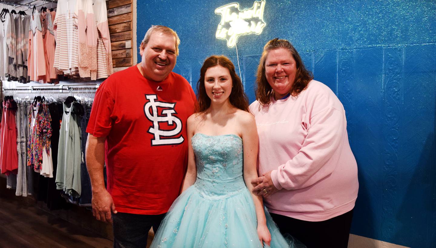 Cassidy Thompson, 16, of Albia High School poses for pictures after picking out her free prom dress during a giveaway on March 16 at Daughters Boutique Color Bar & Beauty Salon in Newton. The event was established by 17-year-old Lydia Schwaller of Grand View Christian School, who has been collecting dresses for years.