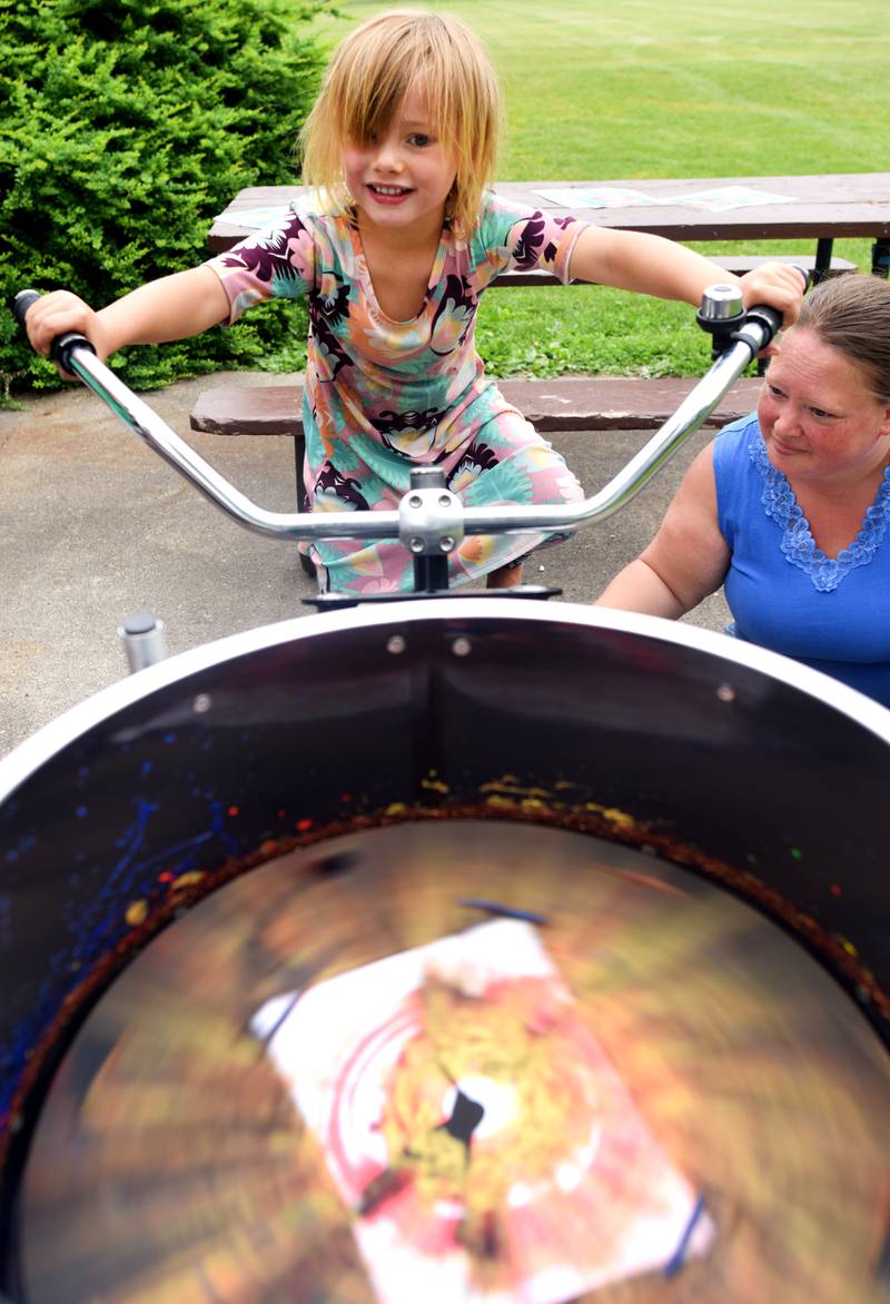 Iowa State University Extension and Outreach hold a spin art bike activity during Newton Fest on Saturday, June 10 at Maytag Park.