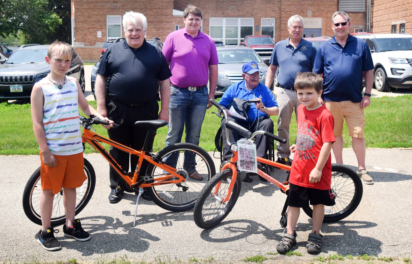 Emerson Hough Elementary students Erick Johnson-Carruthers and Abel Brown pose with their new bikes alongside members of the Newton Masonic Lodge. One third grader and one second grader from each building were selected from a drawing to win a new bike as part of the Book for a Bike program sponsored by Newton Masonic Lodge. The bikes were assembled and provided by Joe Urias, owner of Mojo Cycling.
