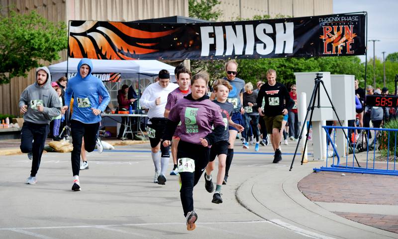 Runners participate in The Phoenix Phase Initiative's fifth annual Run For Her Life 5K and Half-Marathon on May 17 at Legacy Plaza in Newton. More than 110 people showed up for the run.