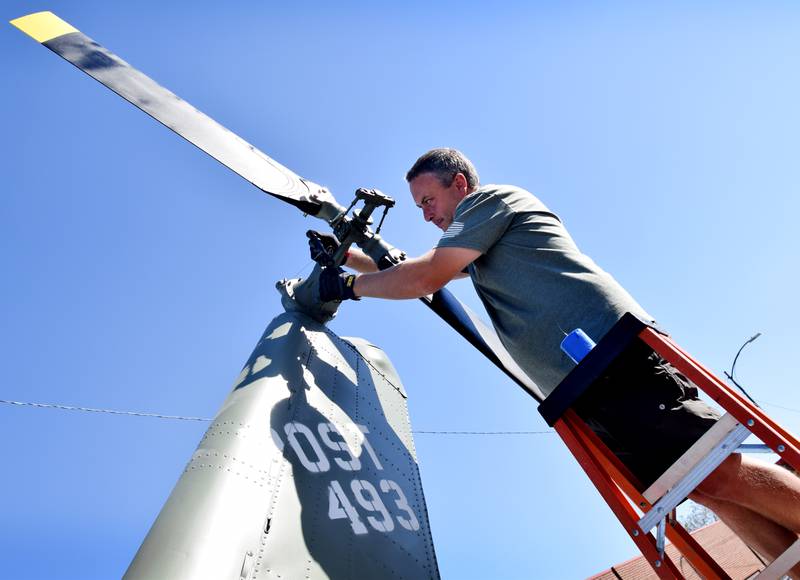 Joe Giannini of Midwest Aerospace works on the tail rotor to a Huey helicopter on Sept. 30 in Baxter.