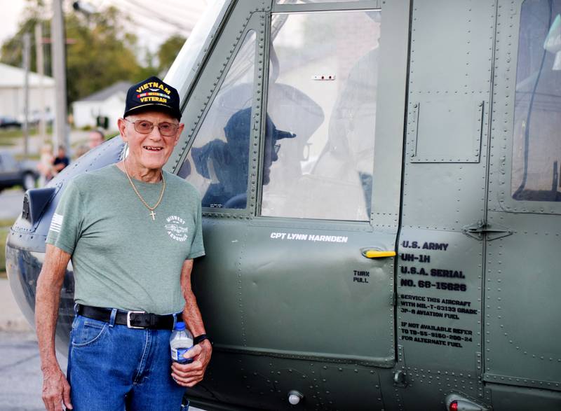 Lynn Harnden, a retired Lt. Colonel of the U.S. Army, poses next to the "Huey" helicopter memorial before it was lifted and affixed to a raised platform on Sept. 30 in downtown Baxter.