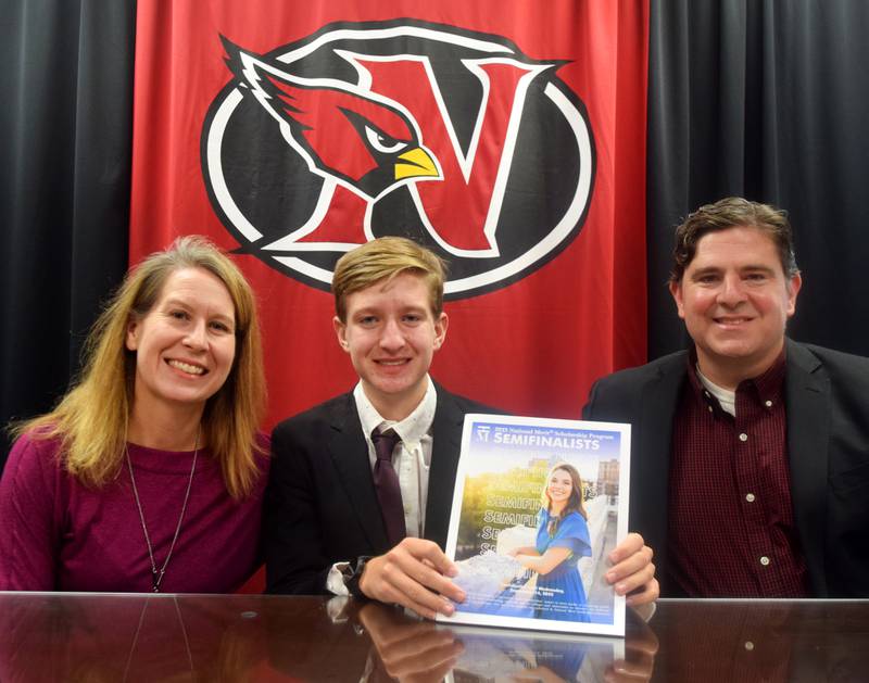 Newton senior Leo Friedman, center, poses with parents Robyn and Bryan Friedman on Sept. 16 at Newton High School after being named a semifinalist for the National Merit Scholarship Program.