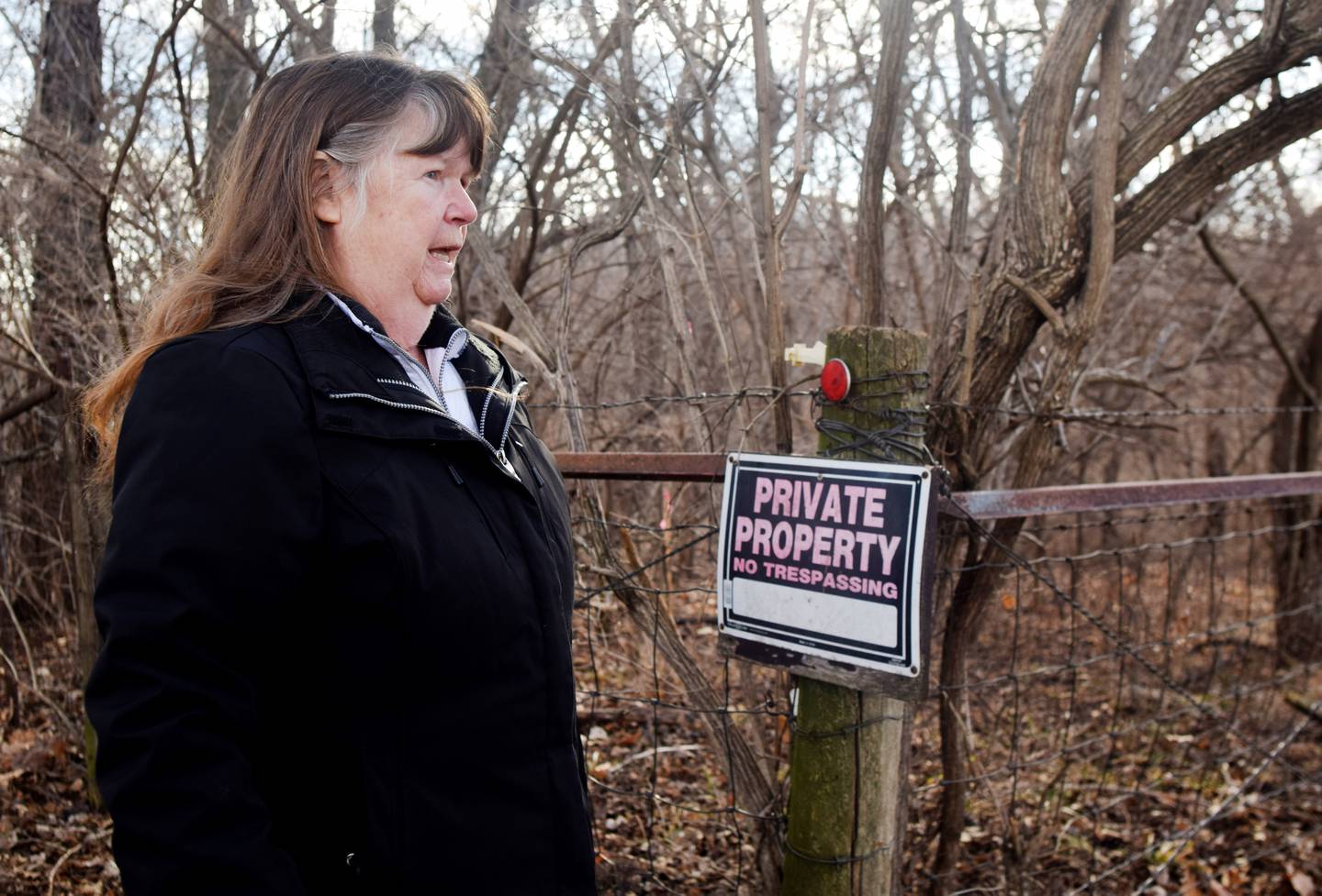 Mary Adams, of rural Colfax, walks along the fence line of her property, which will be moved to make way for the construction of a Level B road that was left unmaintained for several decades. Supervisors argue Jasper County could be liable for failure to maintain if the road is not extended to grant access to another property owner's 20-acre parcel.