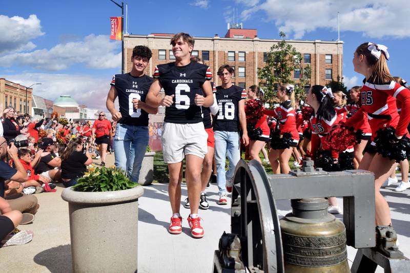 The Cardinals football team arrives for a pep rally Sept. 4 outside the Jasper County Courthouse in downtown Newton.