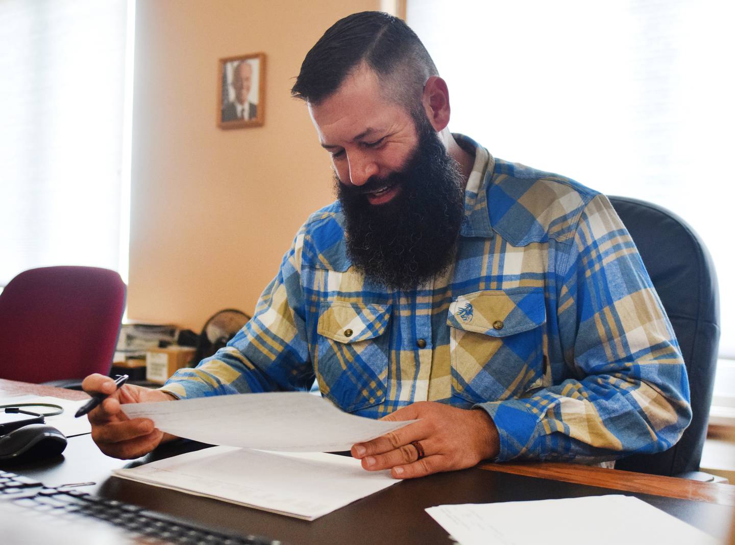 Brandon Talsma, a Republican incumbent running for a seat on the Jasper County Board of Supervisors, looks through documents before adding his signature on Nov. 8 inside the supervisors chambers of the county courthouse in Newton.