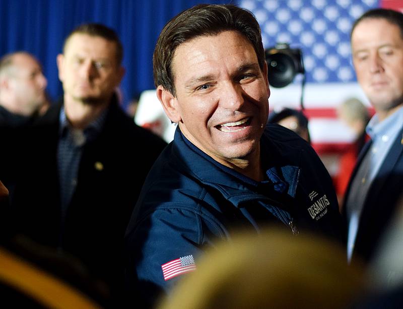 Florida Gov. Ron DeSantis, who is running for president, shakes hands with guests during a campaign stop Dec. 2 at The Thunderdome in Newton. DeSantis finished his 99-county tour in Jasper County with support from local legislators, the governor of Iowa and the leader of an influential conservative group.