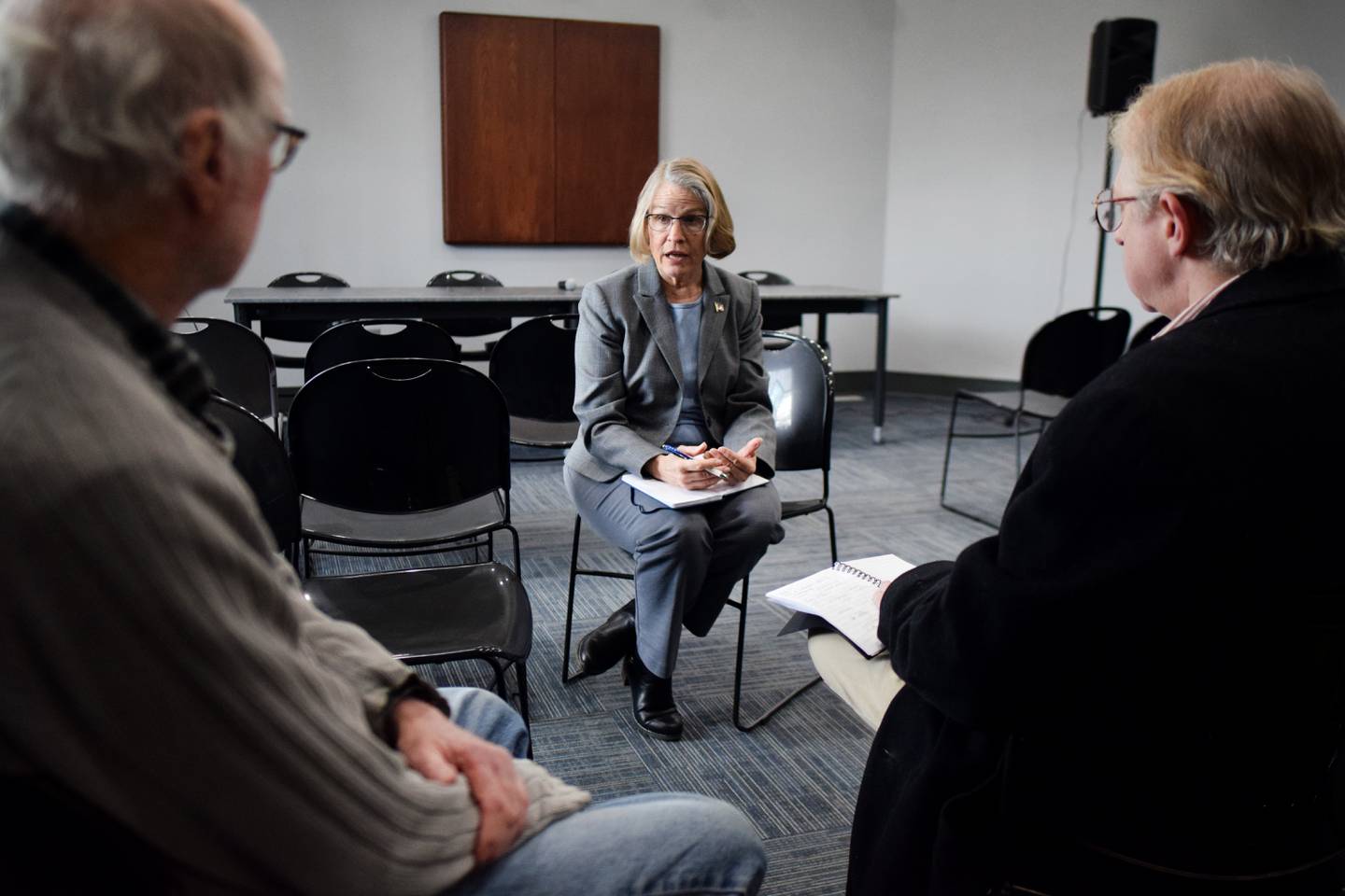 Rep. Mariannette Miller-Meeks, R-Iowa, speaks to local historian Larry Hurto, left, and city council member Mark Hallam, right, during a listening post Feb. 23 at the Newton Public Library. Miller-Meeks spoke extensively about the war between Russia and Ukraine and voiced her support for the latter country defending itself.