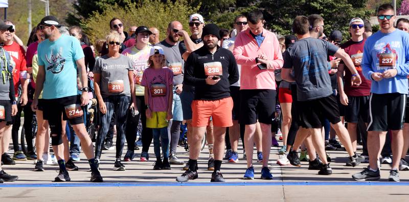 Runners, walkers and young bikers take off for the Run For Her Life 5K organized by nonprofit Phoenix Phase Initiative on April 29 at Legacy Plaza in Newton.