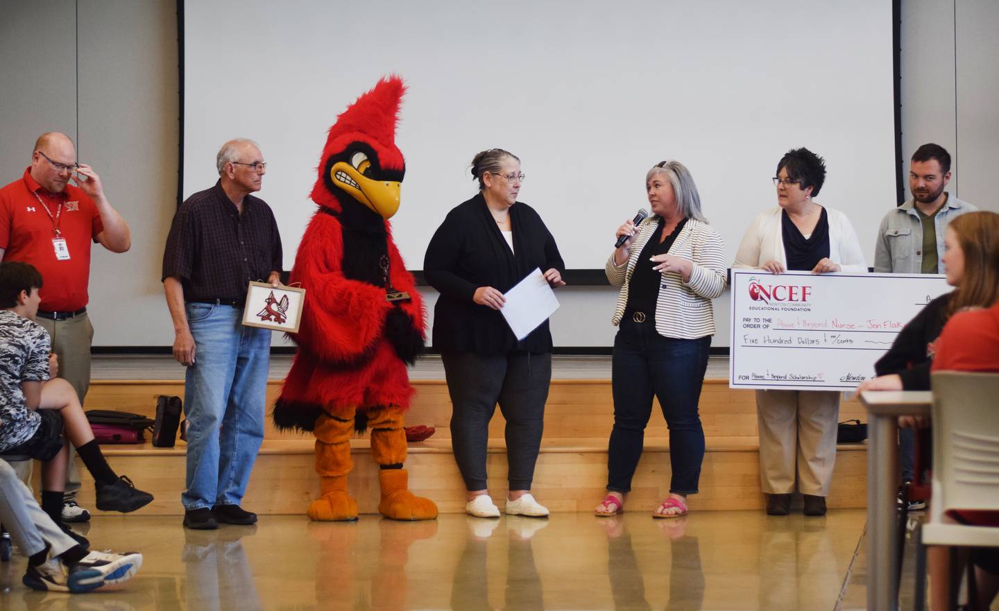 Jen Flake, a school nurse at Berg Middle School, finds out she has received the Above & Beyond Award from Newton Community Educational Foundation.