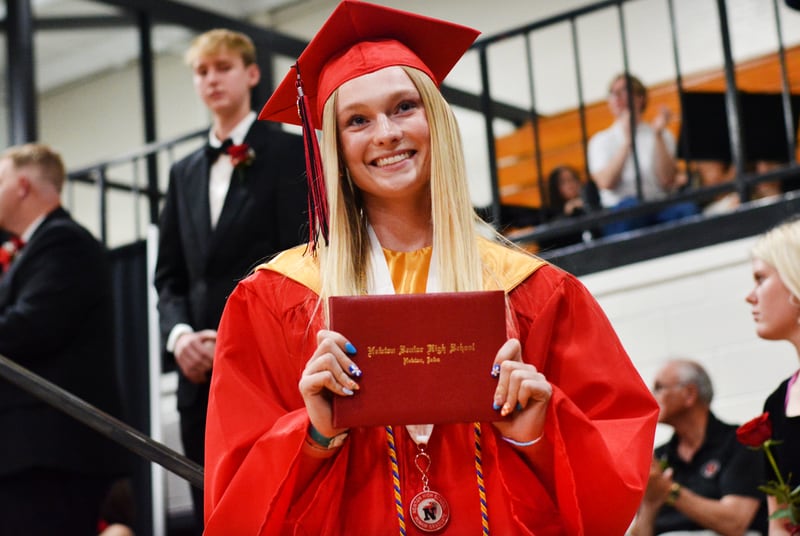 Seniors cross the stage with a smile at the  Newton High School graduation ceremony on May 25 in the high school gymnasium.