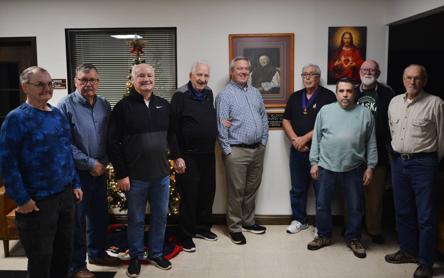 Members of the Knights of Columbus pose for a picture. The Knights of Columbus bell ring for the Salvation Army every holiday season.