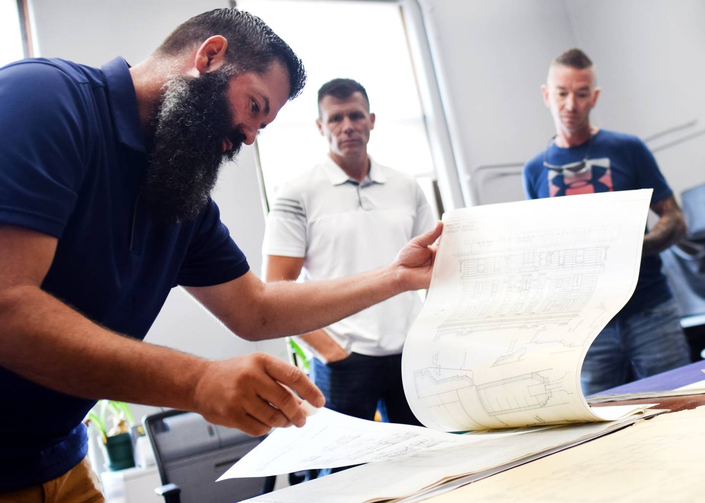 Jasper County Supervisor Brandon Talsma looks through old blueprints of the courthouse to the board of supervisors during an Aug. 1 work session.