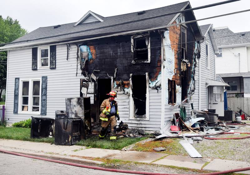 Firefighters from the Newton Fire Department clear out a house that caught fire July 8 near the 400 block of North Third Avenue East.