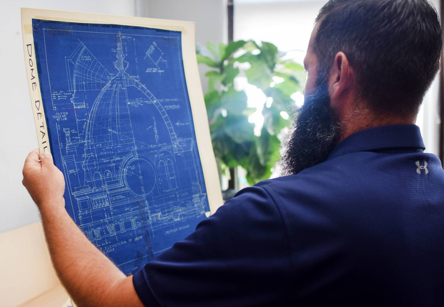Jasper County Supervisor Brandon Talsma looks through old blueprints of the courthouse to the board of supervisors during an Aug. 1 work session.