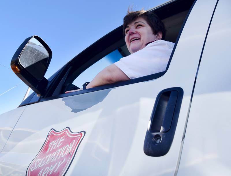 Captain Janelle Cleaveland peeks out the window of the Salvation Army's van on March 25 in the organization's parking lot in Newton. A sizable donation from a local man who died in 2019 can be used to purchase or improve capital items at the Salvation Army, such as a new van.
