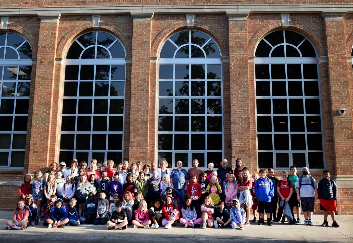 Students, faculty and friends and loved ones of Eloise Anthony pose for a picture in front of a new bench on Sept. 13 at Emerson Hough Elementary School in Newton. The bench was dedicated to Anthony.