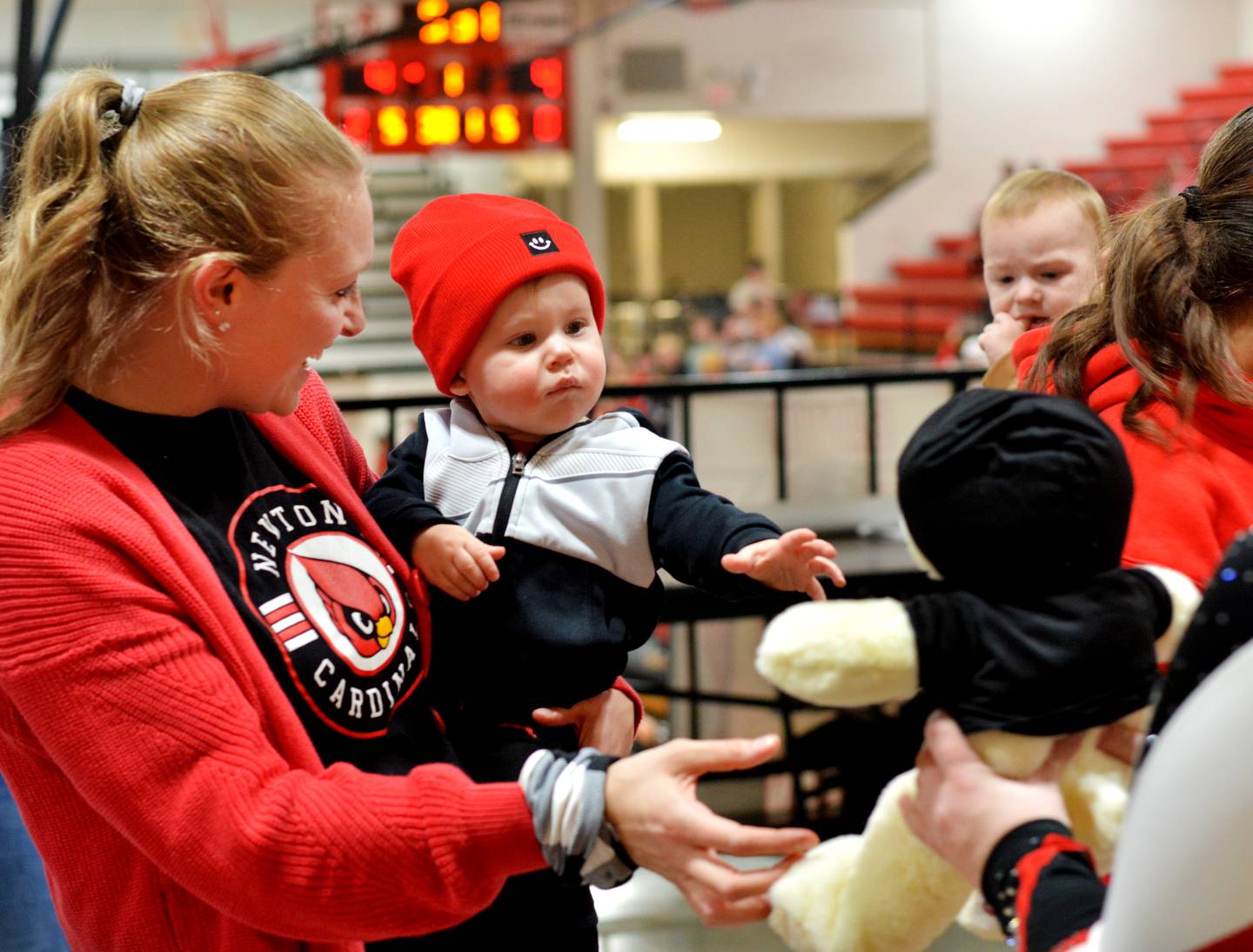 Tatum Hills, 1, reaches for his newly made teddy bear during a fundraiser for the United Way of Jasper County and Newton Pacesetters on Dec. 12 at Newton High School.