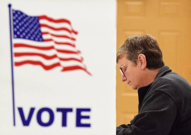 Jan Wolters fills in her ballot during Election Day on Nov. 2, 2021, at the precinct inside St. Luke United Methodist Church in Newton.