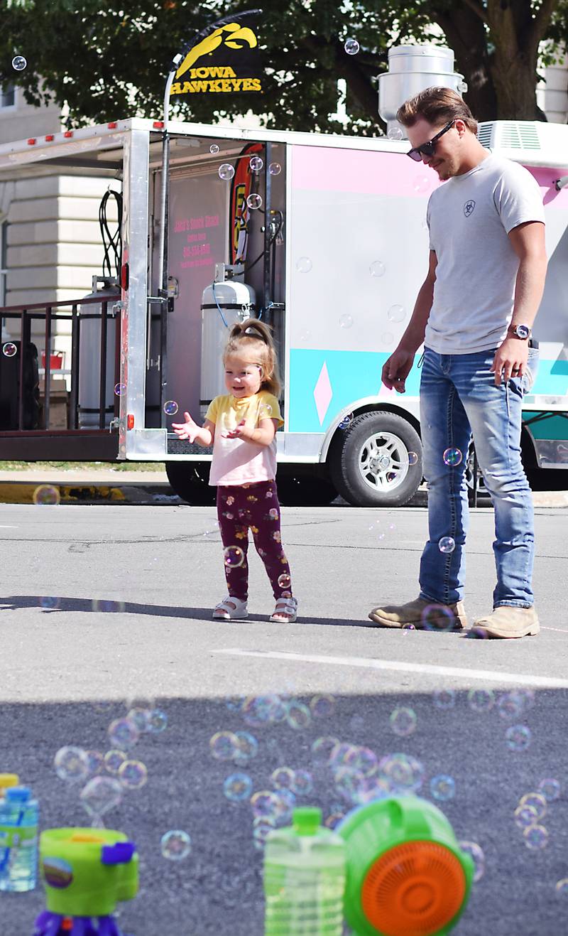 A young visitor of the RVTV celebrations reacts to bubble machines on Sept. 4 in downtown Newton.